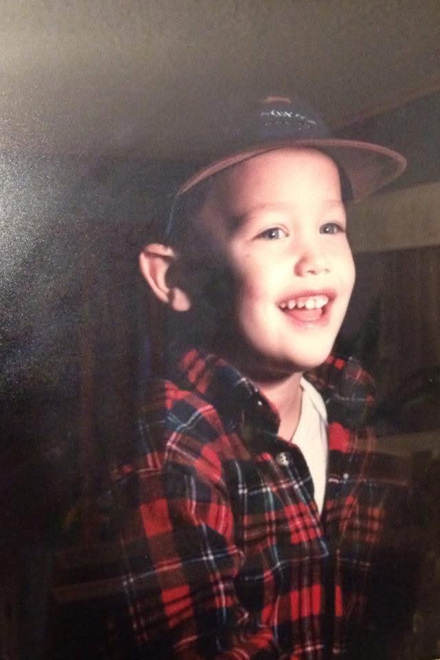 Ryan smiling as a young boy